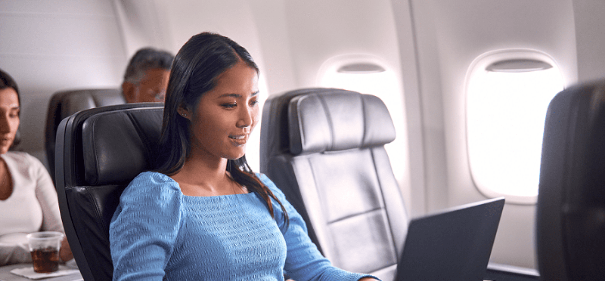 Woman using a laptop on an airplane