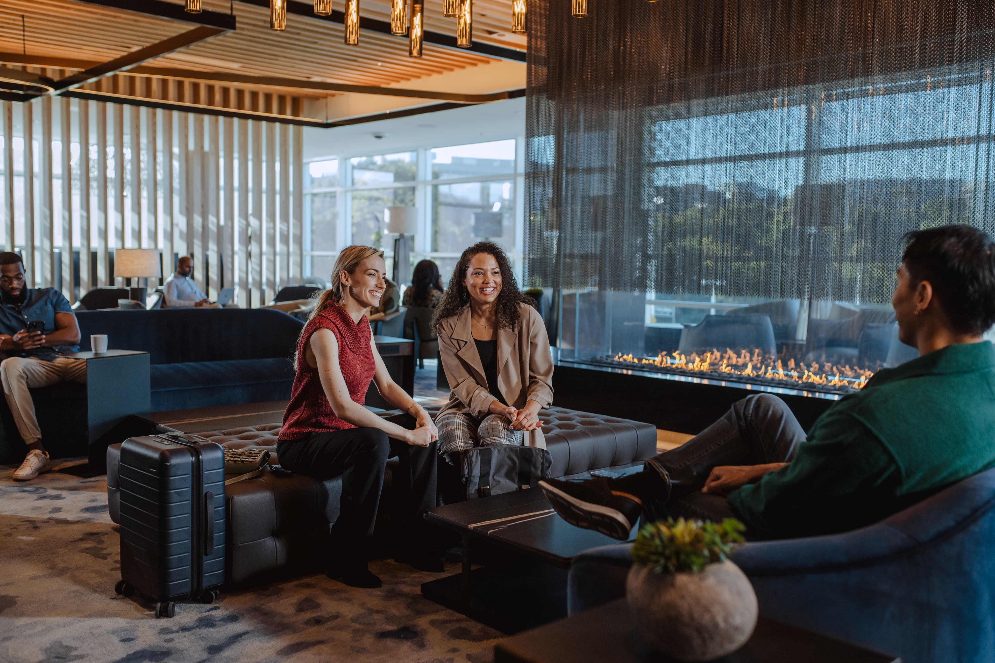 2 women seated in an airport lounge