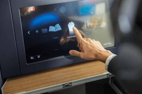 Man interacting with an airline seatback screen
