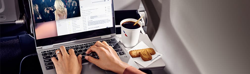 Laptop placed on an airplane fold out tray